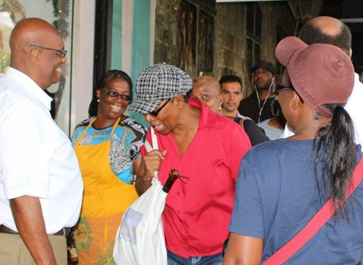 Opposition Leader Arnhim Eustace, left, interacts with persons in Kingstown on Friday. (Photo: NDP/Facebook)