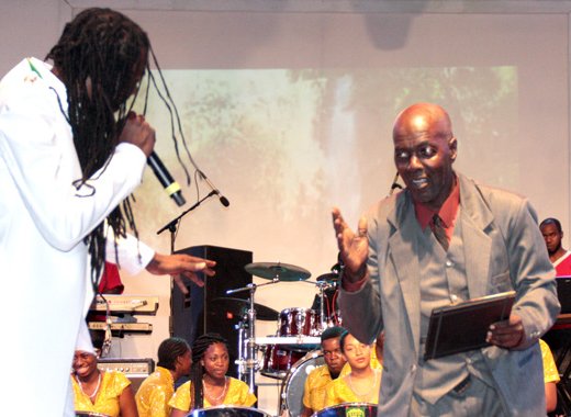 Kenneth Vibrating Scakes Alleyne, left, receives the award from Skinny Fabulous. (Photo: Zavique Morris-Chance/IWN)