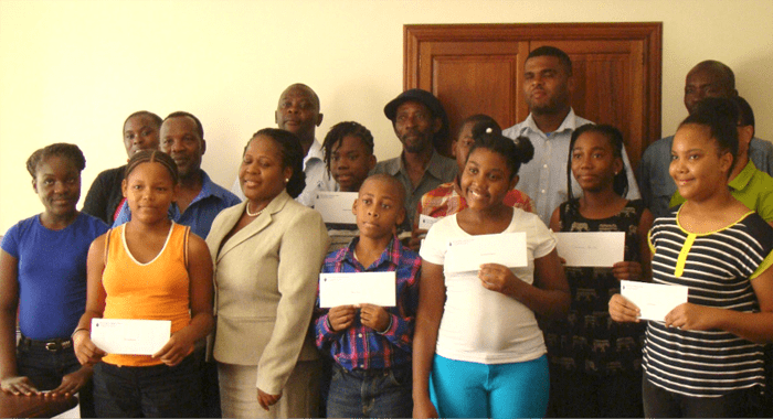 Scholarship and bursary recipients and their parents pose for a photo.