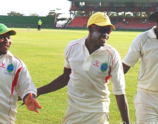 Hat-trick man Keron Cottoy, centre, being congratulated by teammates Alston Bobb, left, and Delorn Johnson. (Photo: E. Glenford Prescott) 