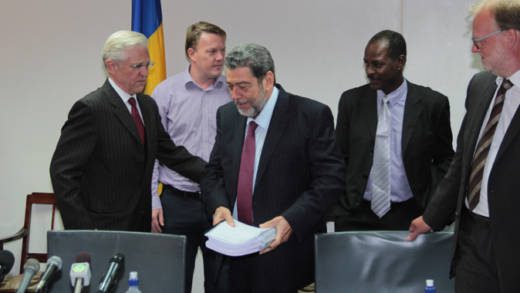 Prime Minister Dr. Ralph Gonsalves holds the three-volume business plan for SVGs geothermal power plant at the media launch in July. Gunnar Orn Gunnarsson, chief operating officer of Reykjavik Geothermal, is furthest right. (IWN photo) 