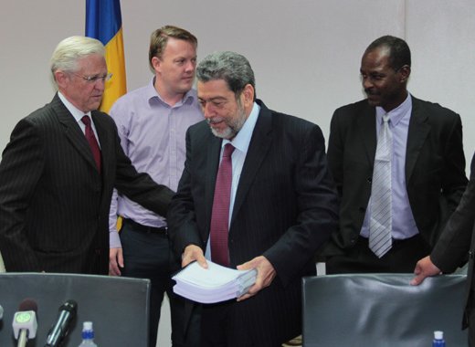 Prime Minister Dr. Ralph Gonsalves holds the three-volume business plan for SVGs geothermal power plant at the media launch in July. Gunnar Orn Gunnarsson, chief operating officer of Reykjavik Geothermal, is furthest right. (IWN photo) 