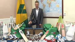 Dr. Christopher Stange, Honorary Consul for St. Vincent and the Grenadines to Northern Ireland pose with youth sporting equipment.