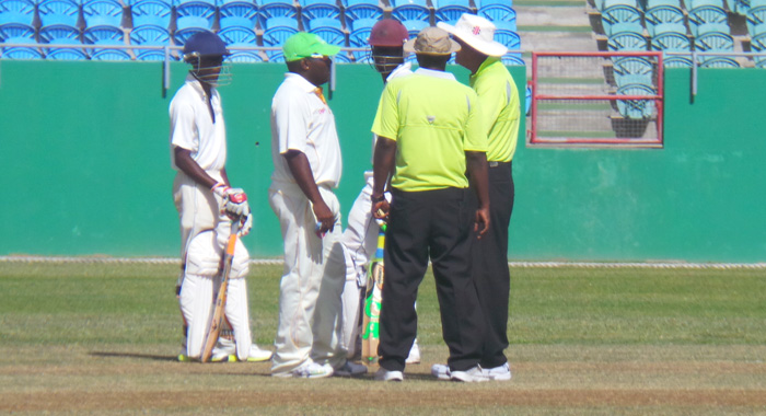 Umpires quell a fuel on the field. (Photo: E. Glenford Prescott)