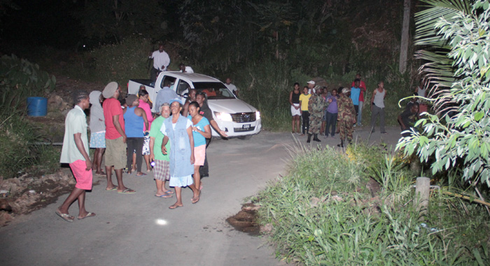 Civilians gather at the scene after police conducted initial investigations Tuesday night. (IWN photo)