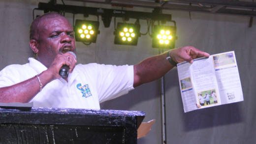 MP for North Leeward, Roland "Patel" Matthews hold up a copy of his manifesto for the constituency on Saturday. (IWN photo)