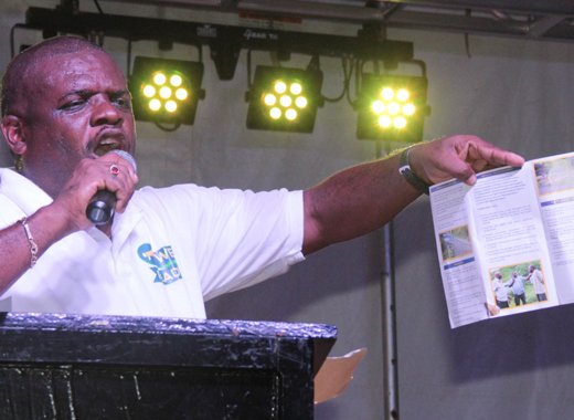 MP for North Leeward, Roland "Patel" Matthews hold up a copy of his manifesto for the constituency on Saturday. (IWN photo)