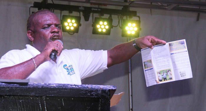 MP for North Leeward, Roland "Patel" Matthews hold up a copy of his manifesto for the constituency on Saturday. (IWN photo)