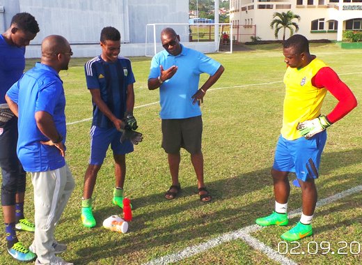 Paul O'Garro, former national goalkeeper, giving current national custodians, Lemus Christopher and Winslow McDowall, some tips. (Photo: E. Glenford Prescott) 
