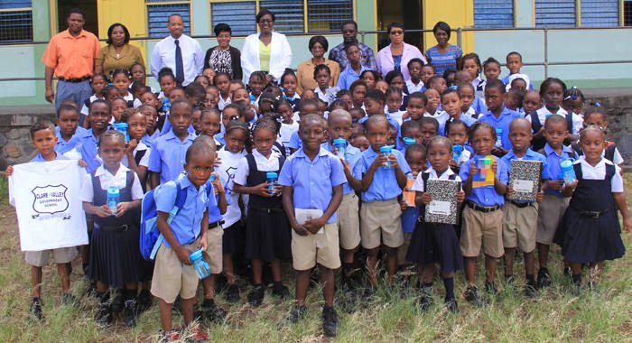 Students pose with school officials and members of the Past Students Association after receiving the supplies. (IWN photo)