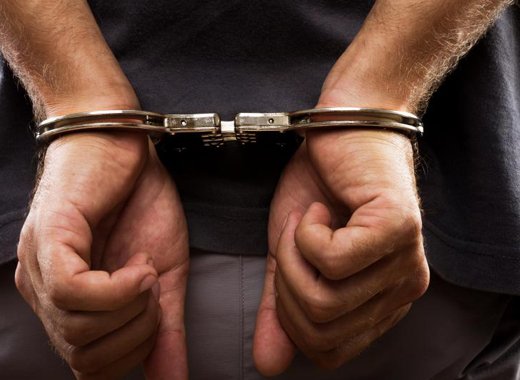 An internet photo of a male in handcuffs. 
