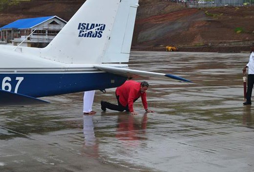 Prime Minister Gonsalves kisses ground at Argyle after disembarking the first aircraft to land at the unfinished airport in November 2015. (Photo: Sydney K. Morgan/Facebook)
