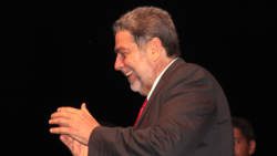 Prime Minister Dr. Ralph Gonsalves claps as supporters react to his announcement of the election date on Nov. 7. (IWN photo) 