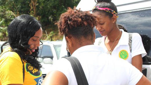 President of North Windwards Young Democrats, Shaffiquer Nanton, interact with students outside the community college during a campaign event. (Photo:NDP/Facebook)