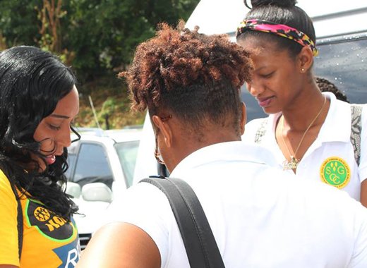 President of North Windwards Young Democrats, Shaffiquer Nanton, interact with students outside the community college during a campaign event. (Photo:NDP/Facebook)