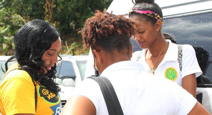 President of North Windwards Young Democrats, Shaffiquer Nanton, interact with students outside the community college during a campaign event. (Photo:NDP/Facebook)
