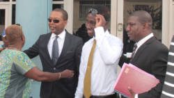 Ben Exeter, second left, and Shabazaah GunMunro George, along with their lawyer, Israel Bruce out side the Kingstown Magistrate Court on Wednesday. (IWN photo)