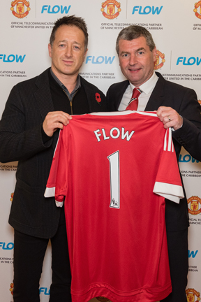 John Reid, president of Cable and Wireless Communication’s consumer group with United legend Denis Irwin.