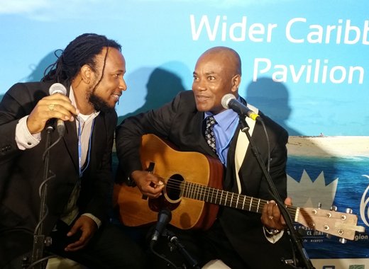 Singers Aaron Silk of Jamaica, left, and Adrian Martinez of Belize perform at the Caribbean Pavilion at the United Nations Climate Talks on Monday. (Photo: Panos)