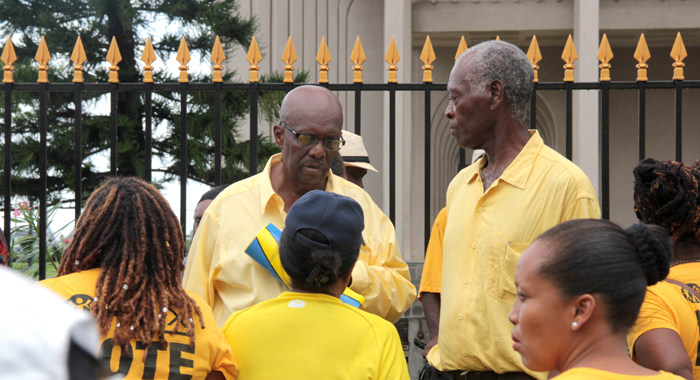 NDP president Arnhim Eustace and other protesters outside the Financial Complex on Monday. (IWN photo)