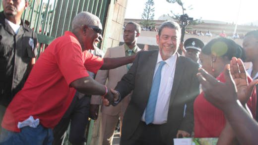 In this January 2016 iWN photo, members of Prime Minster Ralph Gonsalves’ security detail keep a watchful eye as he interacts with persons outside Parliament. Gonsalves said last week that a security detail is a perk of his position. 