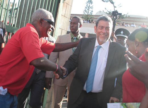 In this January 2016 iWN photo, members of Prime Minster Ralph Gonsalves’ security detail keep a watchful eye as he interacts with persons outside Parliament. Gonsalves said last week that a security detail is a perk of his position. 