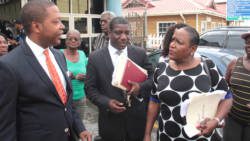 Embattled opposition politician, Ben Exeter, left, chats with his lawyers, Israel Bruce, and Kay Bacchus-Browne, after Monday court appearance. (IWN photo)
