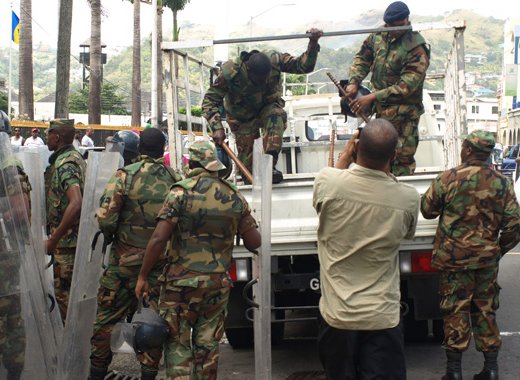 Grenadian journalist Hamlet Mark films the arrival of police at the scene of the protest last Thursday. (IWN photo)