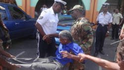 Police officer arrested activist Luzette King in Kingstown on Thursday. (Photo: Carib Update/Facebook)