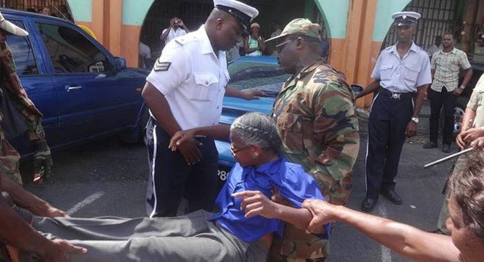 Police officer arrested activist Luzette King in Kingstown on Thursday. (Photo: Carib Update/Facebook)
