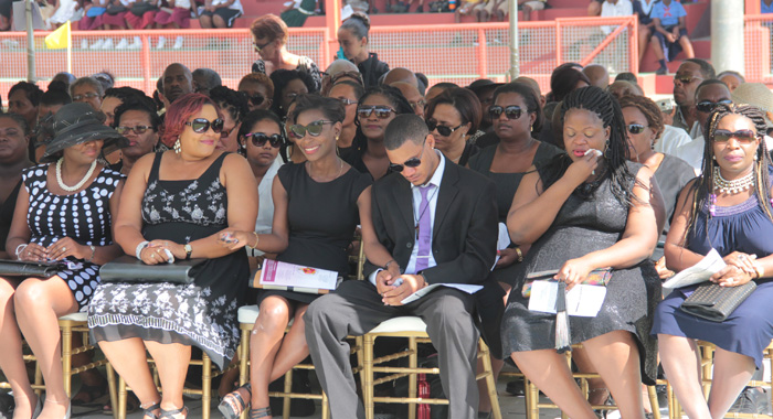 McIntosh's children, second right and fourth right, and other persons at the funeral on Friday. (IWN photo)