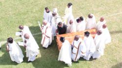 McIntosh's son, Patrick Jr (in black) and clerics carry his casket at Victoria Park on Friday. (IWN photo)