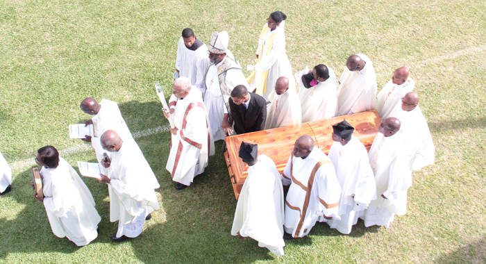 McIntosh's son, Patrick Jr (in black) and clerics carry his casket at Victoria Park on Friday. (IWN photo)