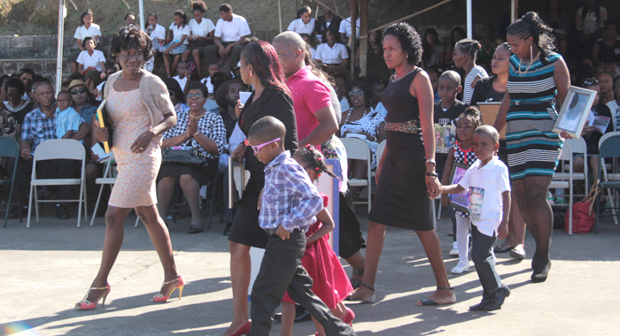Parents and relatives of the deceased students at the memorial service on Tuesday. Edwards is furthest left. 
