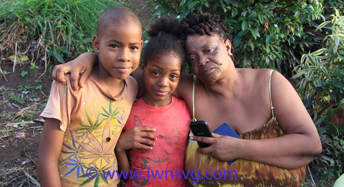 Williams' mother, Arlene Williams, and his children, Reihanna Nanton, 10, and Nyiha Nanton, 11 in Lowman's Hill Sunday evening. (IWN photo) 