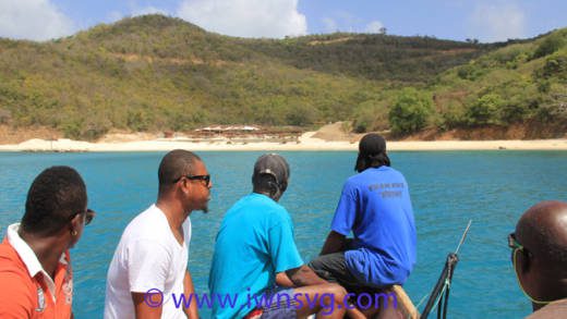 So near, yet so far: Canouan residents on Feb. 7, 2016 use boats to access L'Anse Guyac bay, a beach on the island, to which they are denied access by land. (IWN photo)