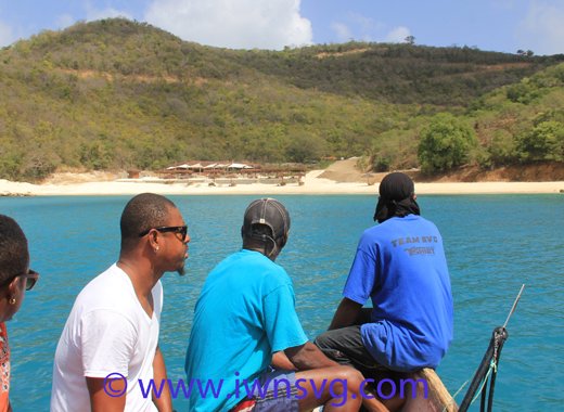 So near, yet so far: Canouan residents on Feb. 7, 2016 use boats to access L'Anse Guyac bay, a beach on the island, to which they are denied access by land. (IWN photo)