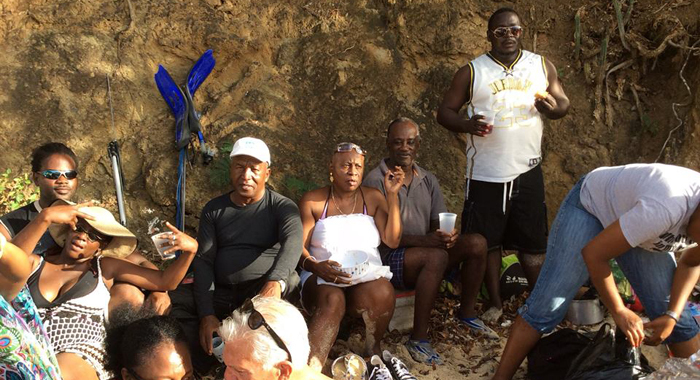 MP for the Southern Grenadines, Terrance Ollivierre, standing, and other persons on a picnic on L'ance Guyac in January. (Photo: Margaret London/Facebook)