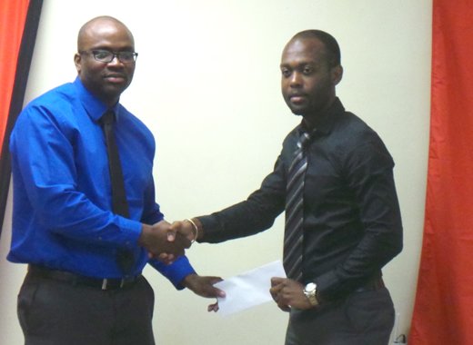  Syran Clarke, of Scotiabank, left, and Kishore Shallow of the SVGCA. (Photo: E. Glenford Prescott)