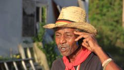"Pirates Retreat" owner, Anthony "Shadow" on Saturday talks to someone on his cellphone about the fallout from the attack on the yacht last week. (IWN photo)