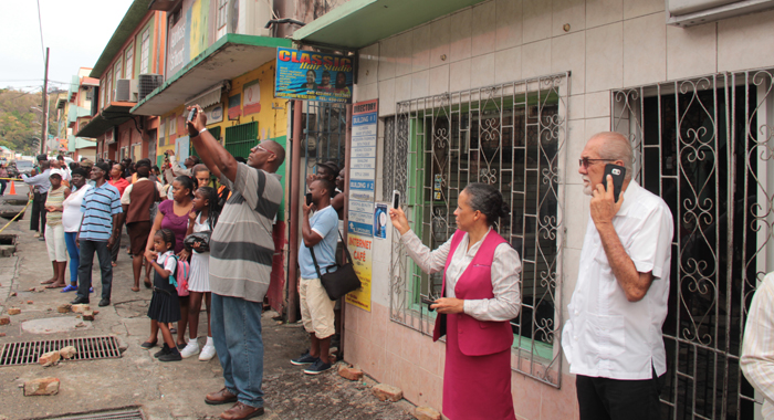 Minister of Works, Sen. Julian Francis, right, and other onlookers at the scene. (IWN photo)
