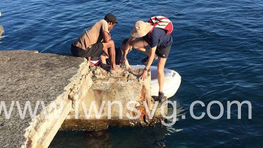 Visitors embark at the dilapidated jetty at Chateaubelair in March 2013. (iWN photo)