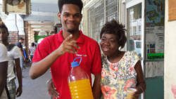 A Digicel Call Centre agent spreading real care by feeding the homeless.