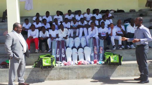 Fitzaudy Wright of Scotiabank hands over the equipment to Kishore Shallow of the SVG Cricket Association.