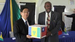 Taiwan Ambassador to SVG, Baushuan Ger, left, handed over the items to Minister of National Mobilisation, Frederick Stephenson.