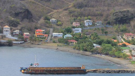 A police officer stationed at Straker's house, furthest right, open fire on the men, one of whom was later found in a pirogue anchored off jackson Bay. (IWN photo)