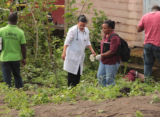Police and medical personnel at the crime scene on Thursday. (IWN photo)