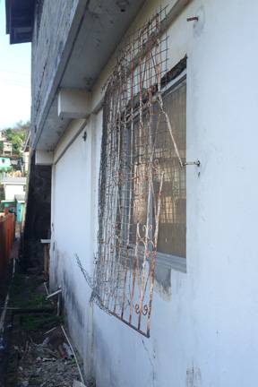 Burglars entered the supermarket after prying off the burglars bars from a window. (IWN photo)