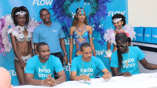 Flow brand ambassadors Hyper4000, Rodney Small and Skinny Fabulous pose with the company's country manager, Wayne Hull, and models after signing a contract at Friday's launch. (IWN photo)