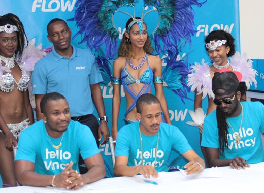 Flow brand ambassadors Hyper4000, Rodney Small and Skinny Fabulous pose with the company's country manager, Wayne Hull, and models after signing a contract at Friday's launch. (IWN photo)